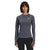 A woman with dark hair wears The North Face Womens Winter Warm Essential Crew, black pants, and an adjustable suspension backpack as she stands facing forward and smiles against a plain white background.
