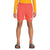 A person wears a long-sleeve yellow shirt, coral pink The North Face Boys Amphibious Class V Short with recycled polyester and FlashDry tech, and black The North Face slide sandals, standing against a plain white background.