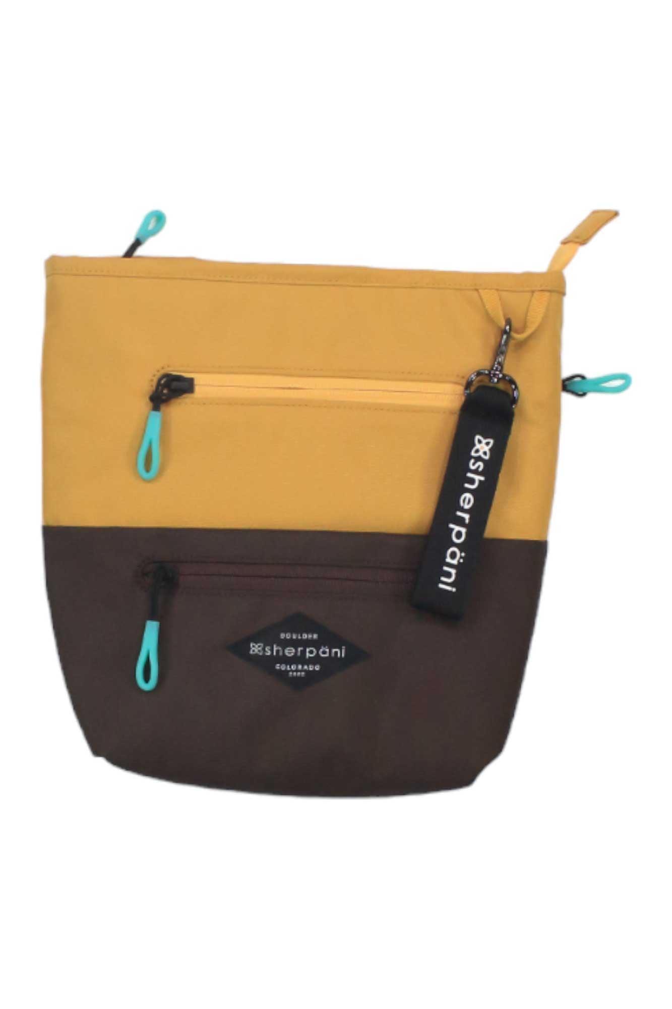 The Sherpani Women's Sadie Cross Body Bag is a two-tone pouch made from recycled materials, with a yellow top, brown bottom, two zippered pockets with turquoise pulls, and a black Sherpani keychain on the top zipper.