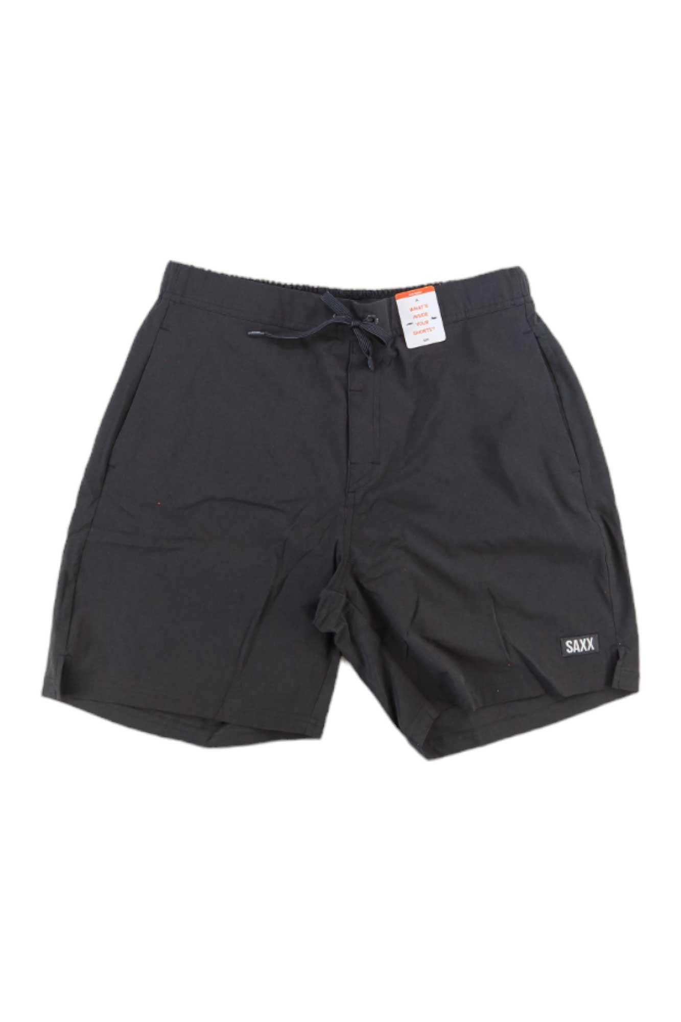 The SAXX Men's Sport 2 Life 2N1 7 Inch Short is a black men's short with an elastic waistband, drawstring, side pockets, 4-way stretch fabric, and a small label near the left leg hem.