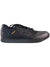 The Pearl Izumi Men's X-Alp Flow Shoe is a black low-top with laces, a perforated toe area, textured sole, and small brown side tag—perfect for use as flat pedal or casual men's mountain bike shoes.