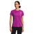 A woman in a bright pink The North Face Womens Elevation SS Top made from recycled polyester and black pants stands facing forward with hands at her sides against a plain white background.
