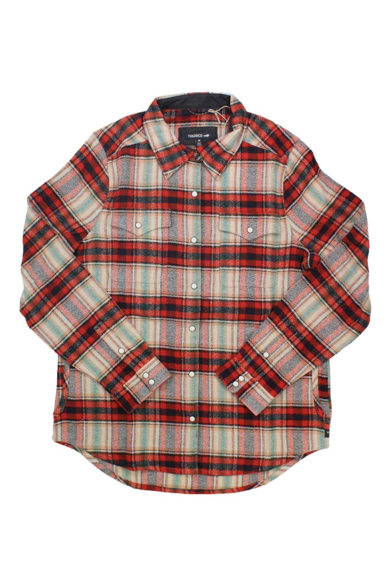 The Toad & Co Womens Folk Yeah Shirt Jacket is a long-sleeve button-up made from recycled wool, featuring a red, black, beige, and green plaid. It has two chest pockets with button flaps and buttoned cuffs.