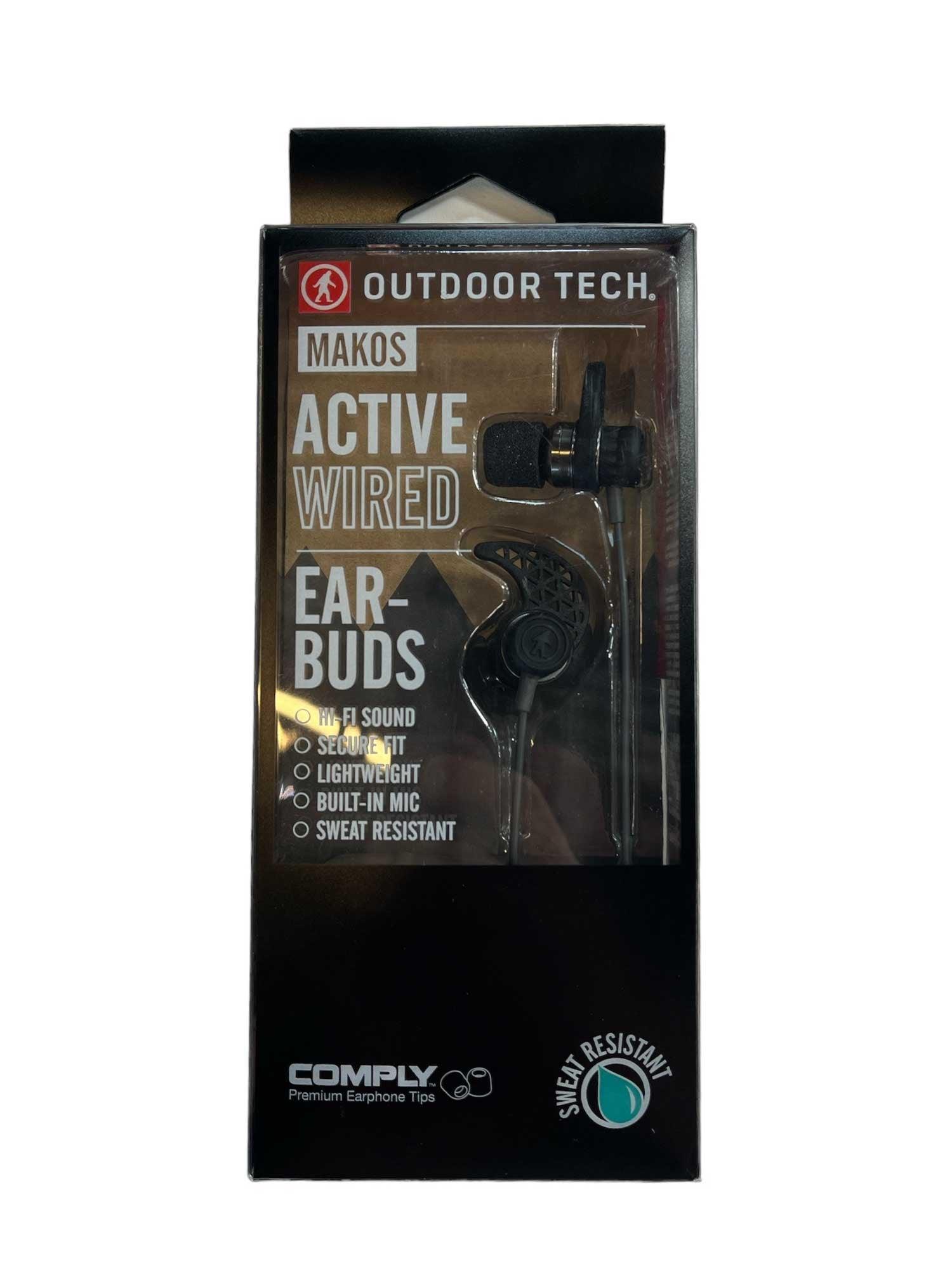 A box of Outdoor Tech Makos All Sport Earbuds with Hi-Fi sound, secure fit, lightweight, sweat-resistant, built-in mic, universal controls, and Comply premium tips. The earbuds are visible through the packaging.
