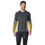 A man stands smiling against a white background, wearing the Smartwool Men's Merino Sport 150 LS Crew—a men's long sleeve dark gray athletic running shirt with yellow accents—and matching dark athletic pants.