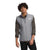 A young man with curly hair wears The North Face Men's Canyonlands Hybrid Vest over a dark long-sleeve shirt, standing facing forward with a neutral expression against a plain white background.