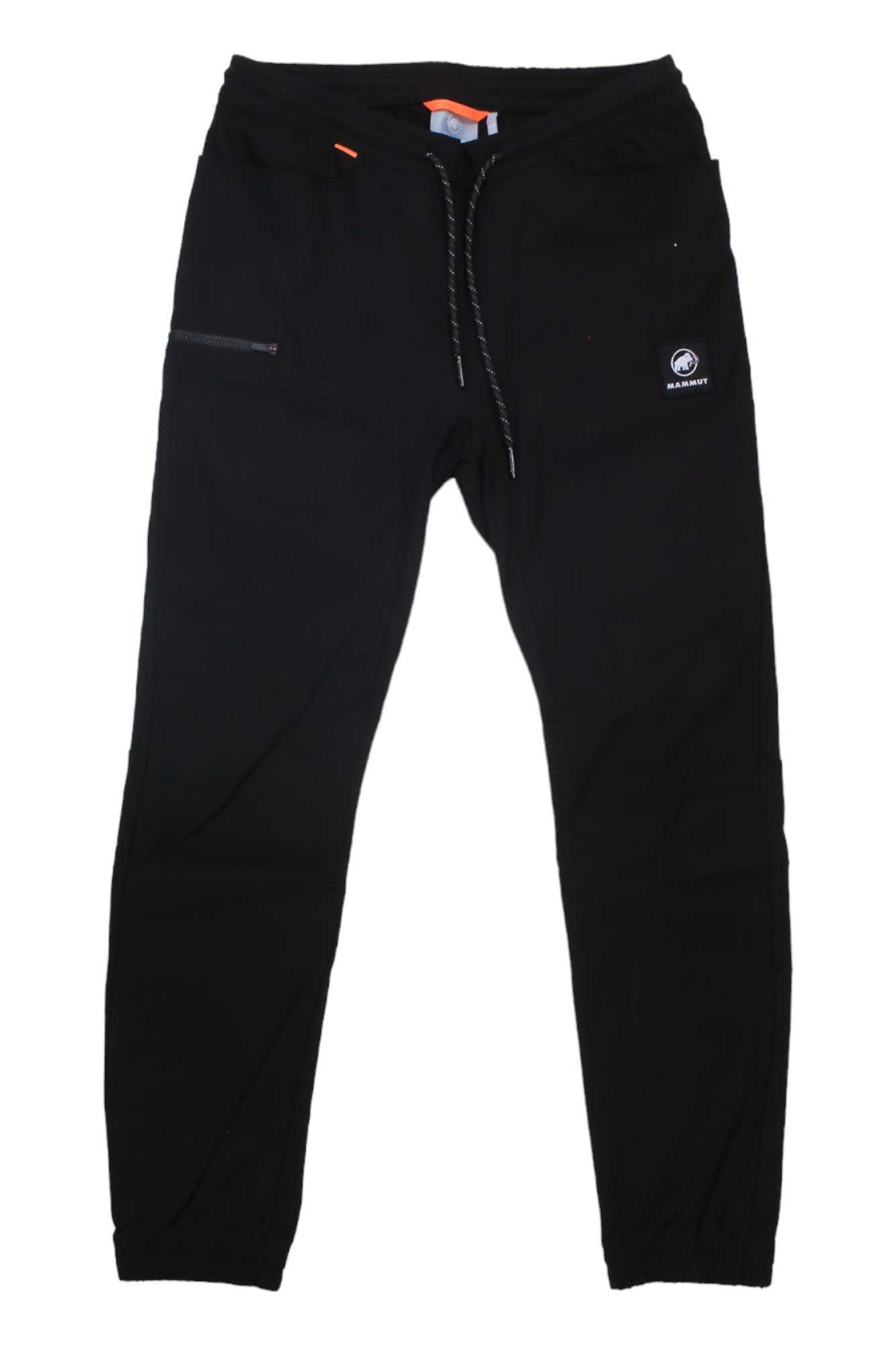 The Mammut Women's Massone Pant features a black design with a drawstring waistband, left zippered pocket, water-repellent fabric, and a small circular logo on the right thigh.