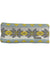The Turtle Fur Women's Apres Headband is a knit accessory with a geometric pattern in gray, yellow, and light blue, plus a small rectangular fabric tag on one side.
