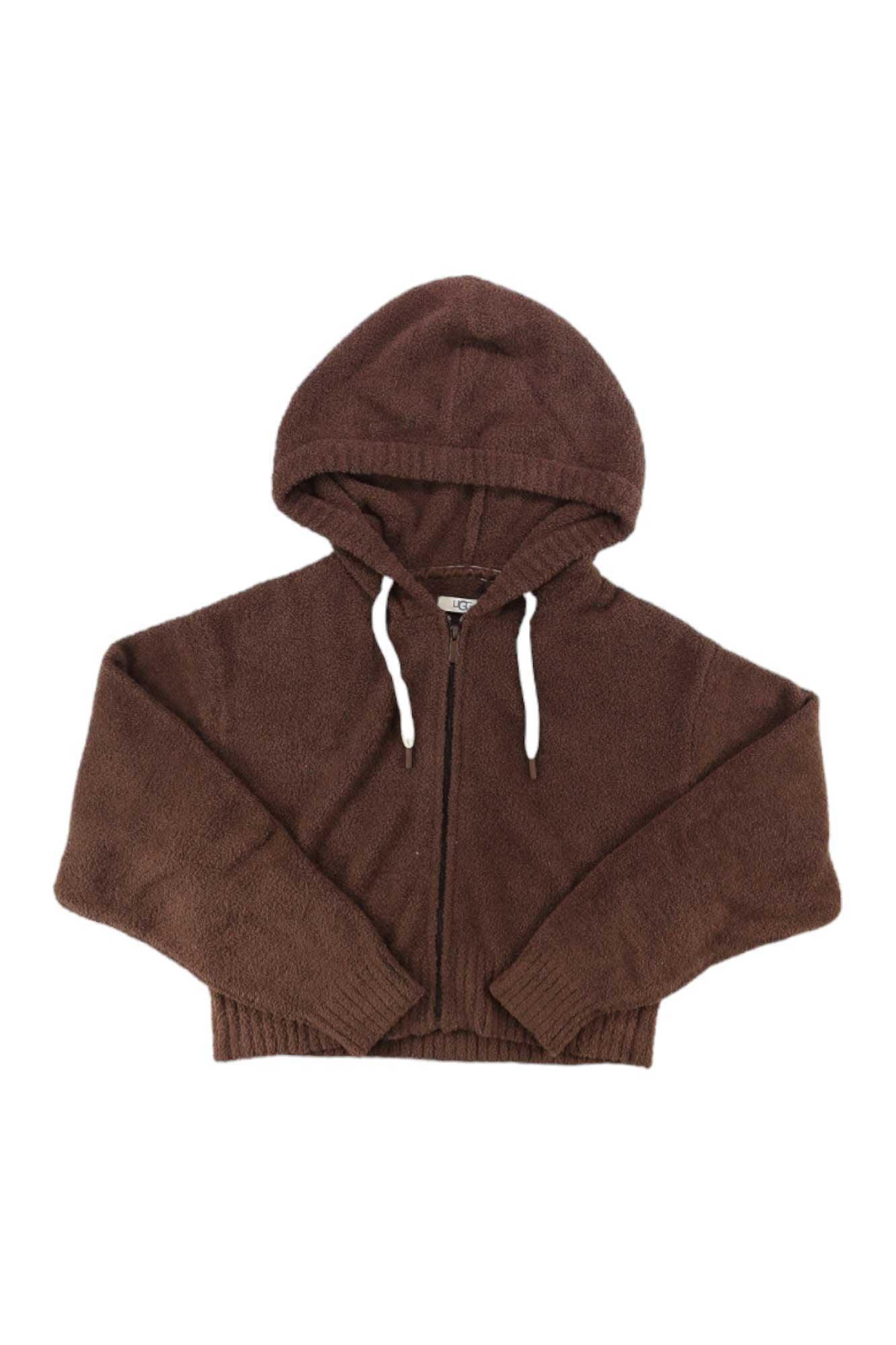 The UGG Women's Hana Zip Hoodie, a cozy brown knit with long sleeves, ribbed hem, and white hood drawstrings, is shown laid flat on a white background.