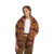 A woman with braided hair wears The North Face Women's Campshire Fleece Jacket, featuring brown and maroon patterns, over a white crop top and brown pants. She stands with her hands in the jacket's pockets against a plain white background.