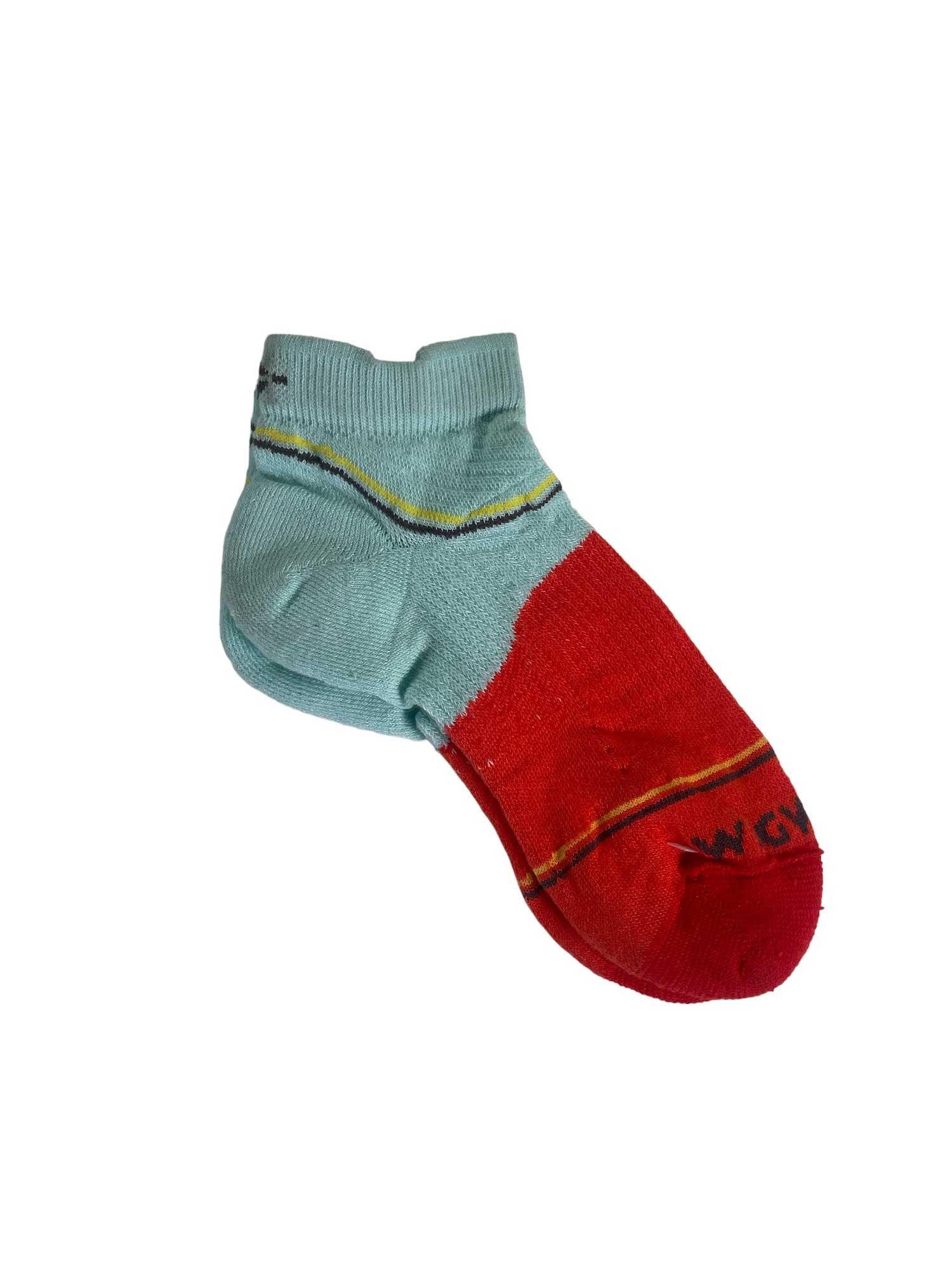The Wigwam Surpass Lightweight Low Sock is a single, lightweight low sock with a light blue upper, red lower half, and yellow stripe. It has a cushioned foot for comfort, black text near the toe, and is displayed flat on a white background.