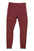 A pair of maroon Saucony Women's Fortify 7/8 Tights, high-waisted and made from recycled polyester, with a small reflective logo on the left thigh, is shown lying flat on a white background.