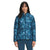 A woman faces forward against a plain white backdrop, wearing The North Face Women's Printed ThermoBall Eco Hoodie—a blue, patterned, lightweight jacket with recycled polyester insulation.