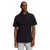 A man wearing The North Face Mens Terrain Polo in black and light gray pants stands against a white background, looking slightly to the side with a neutral expression.