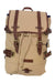 The United By Blue Derby Tier Backpack is a tan canvas bag with brown leather straps, gold buckles, a drawstring closure, top flap, side straps, and a top handle—perfect for stylish adventures.