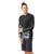 A person smiles and looks to the side, wearing a black Smartwool Men’s Mountain Bike LS Jersey with gray and white patterns, “Smartwool” on one sleeve, and black shorts. The jersey is moisture-wicking for comfort.