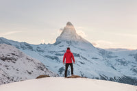 person standing in front of snowy man