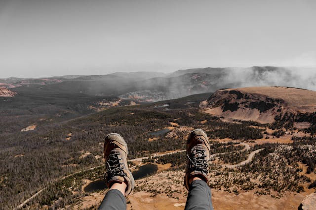 hiker relaxing on a mountain after reaching the peak