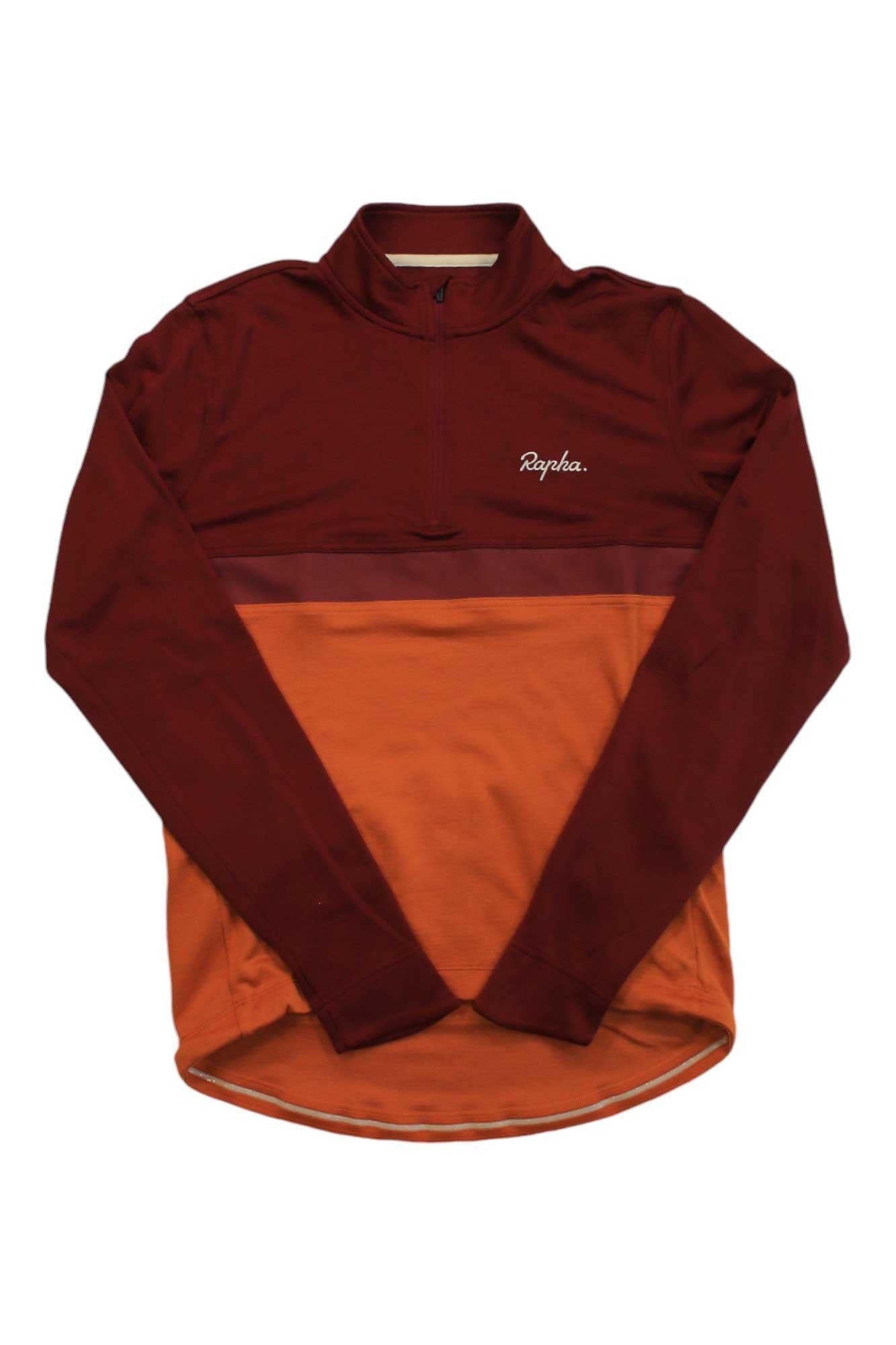 The Long Sleeve Club Jersey is a cycling jersey with a half zipper, maroon upper section and sleeves, orange lower section, and the white “Rapha” logo on the chest.
