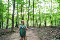 kid hiking on a trail with a backpack