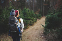 A mother hiking with her child on her back