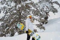 man carrying snowboard