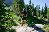 man hiking through woods