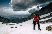 man trekking through snowy wilderness