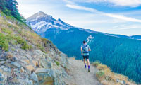 man on hiking trail wearing a hydration pack