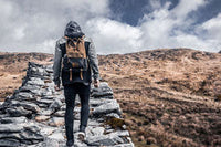 a man hiking on rocks