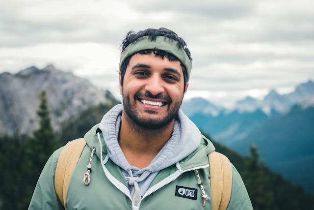 A man wearing layered shirts outdoors