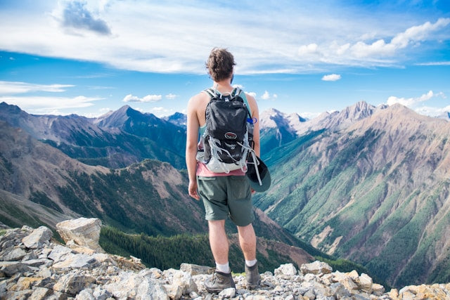 man wearing shorts looking at mountains