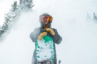 Man holding green snowboard