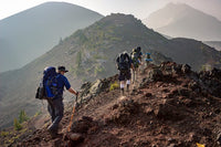 group trekking up a mountain