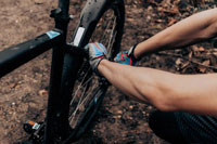 person repairing bike wheel