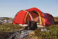 Hiking boots in front of a tent