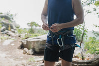 a man wearing shorts and climbing gear