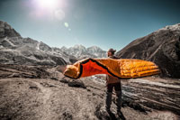 man holding a sleeping bag