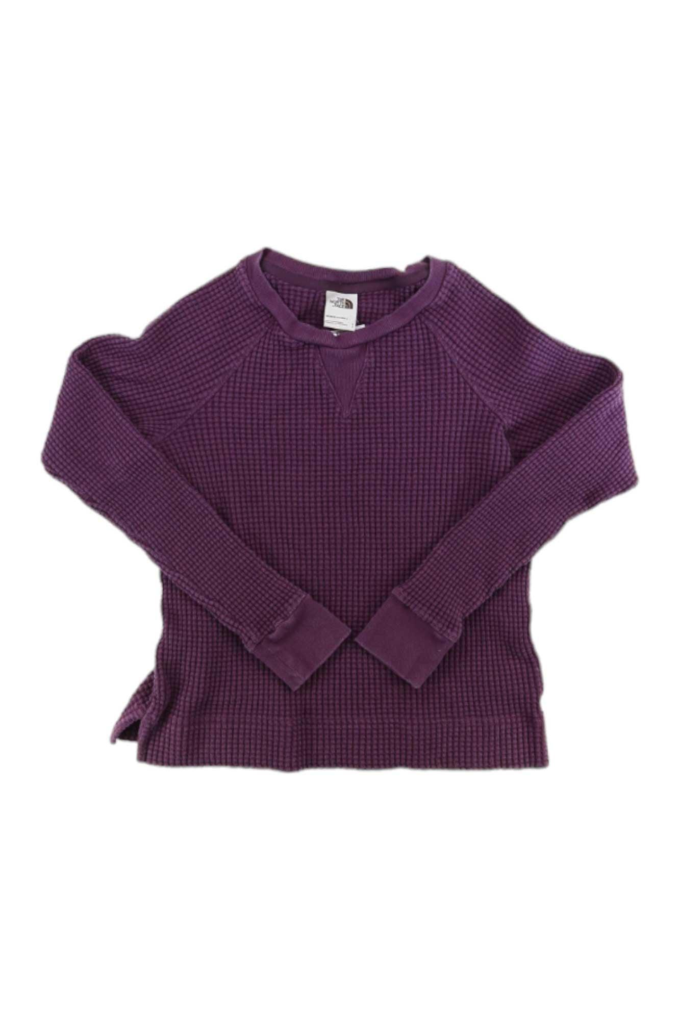 The North Face Womens Chabot LS Crew Top is a purple, long-sleeve cotton thermal knit pullover with raglan sleeves and ribbed cuffs, shown laid flat on a white background.