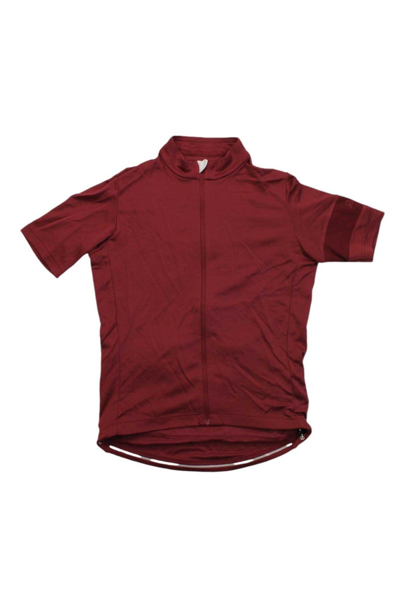 The Rapha Mens Classic Jersey in maroon features short sleeves, a front zipper, high collar, and extended back hem—an iconic cycling top shown laid flat on a white background.