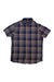 The Mens Plaid Short Sleeve Button Up features a blue, brown, and beige plaid pattern, soft cotton fabric, a chest pocket, and a collar. It's shown laid flat on a white background for an easy view of its details.