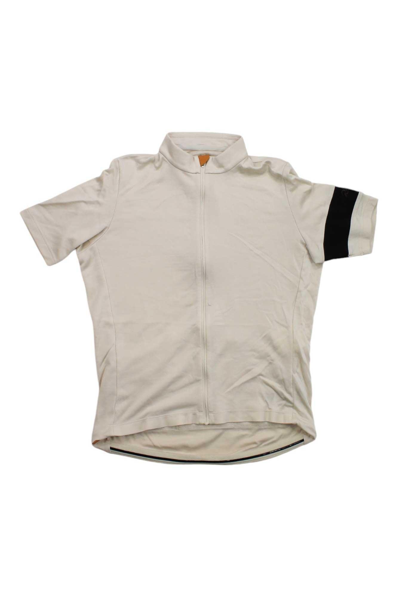 A short-sleeved light beige Rapha Mens Classic Jersey with a front zipper and a black band on the left sleeve, displayed flat against a white background—an iconic cycling jersey.