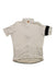 A short-sleeved light beige Rapha Mens Classic Jersey with a front zipper and a black band on the left sleeve, displayed flat against a white background—an iconic cycling jersey.