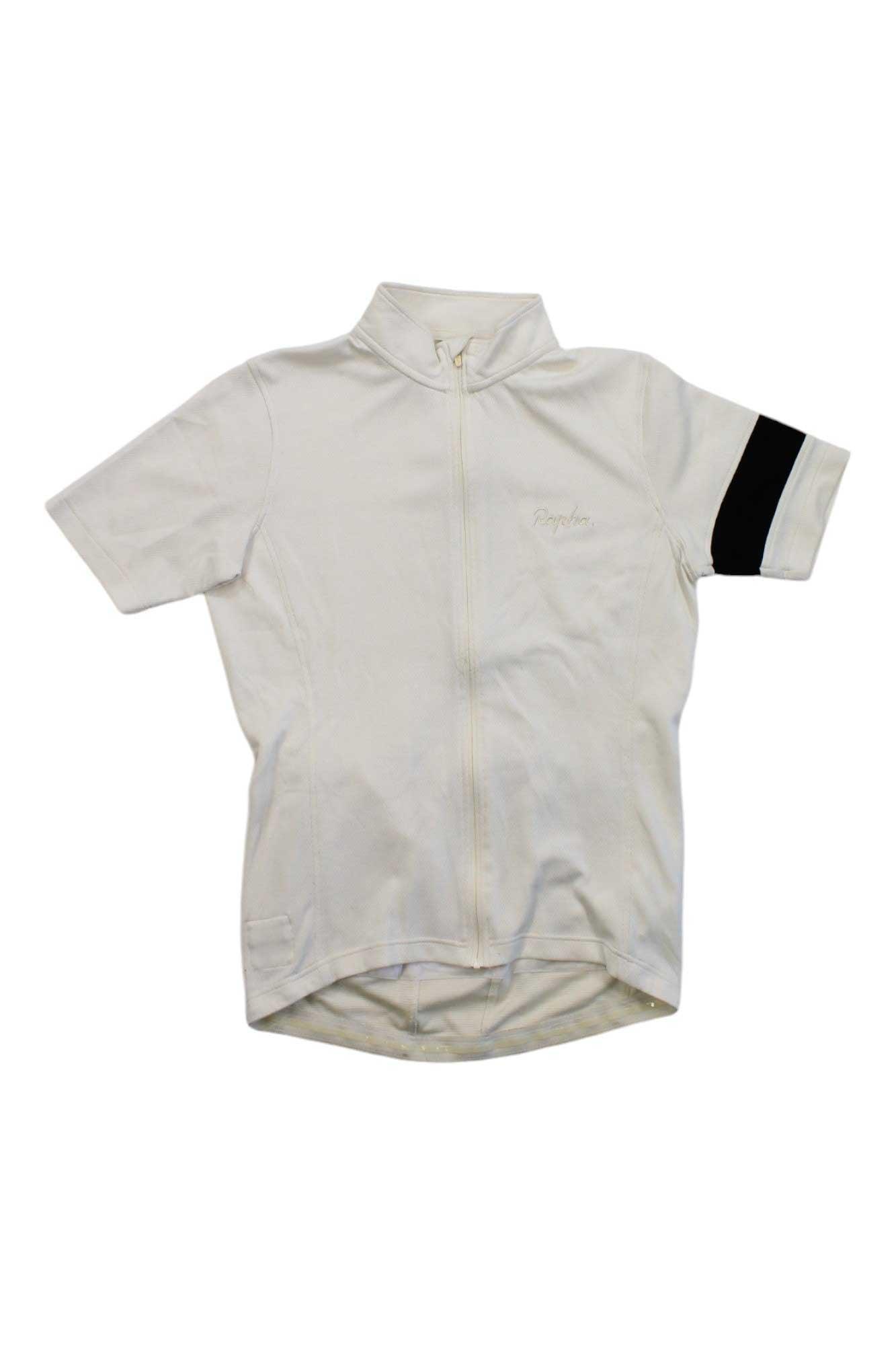 The Rapha Mens Pro Team Lightweight Jersey is a short-sleeve, off-white cycling jersey with a full front zipper, black band on the left sleeve, and small collar. Designed for superior moisture management, it's shown laid flat on a white background.