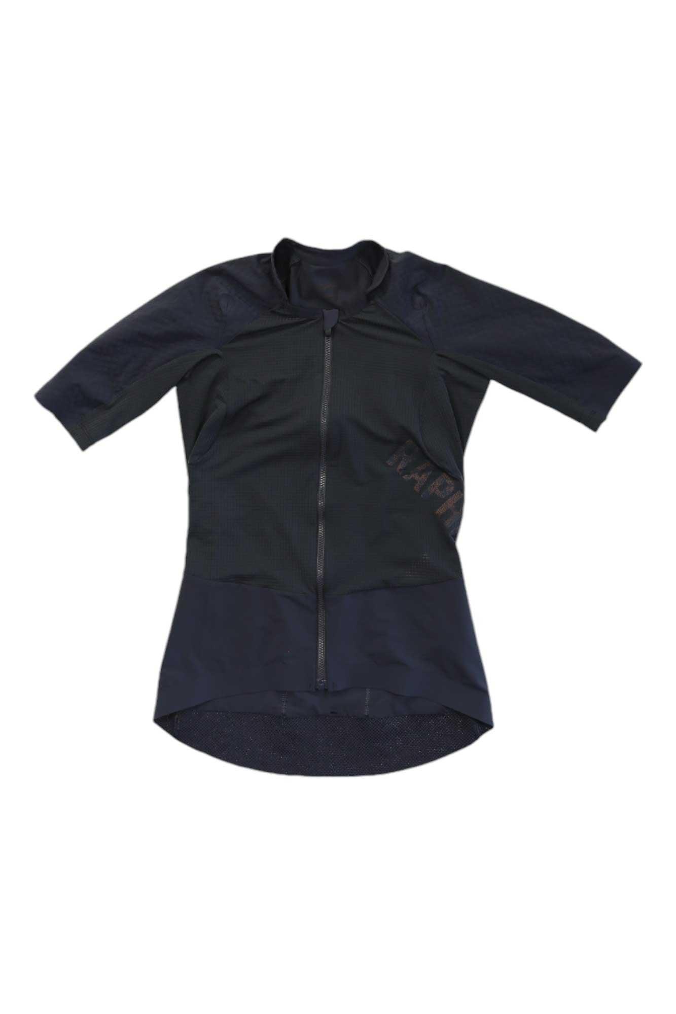 The Rapha Pro Team Gravel Jersey, in black, features a breathable fabric, full front zipper, extended rear hem, UV protection, and subtle left-side text. The jersey is displayed flat on a white background.