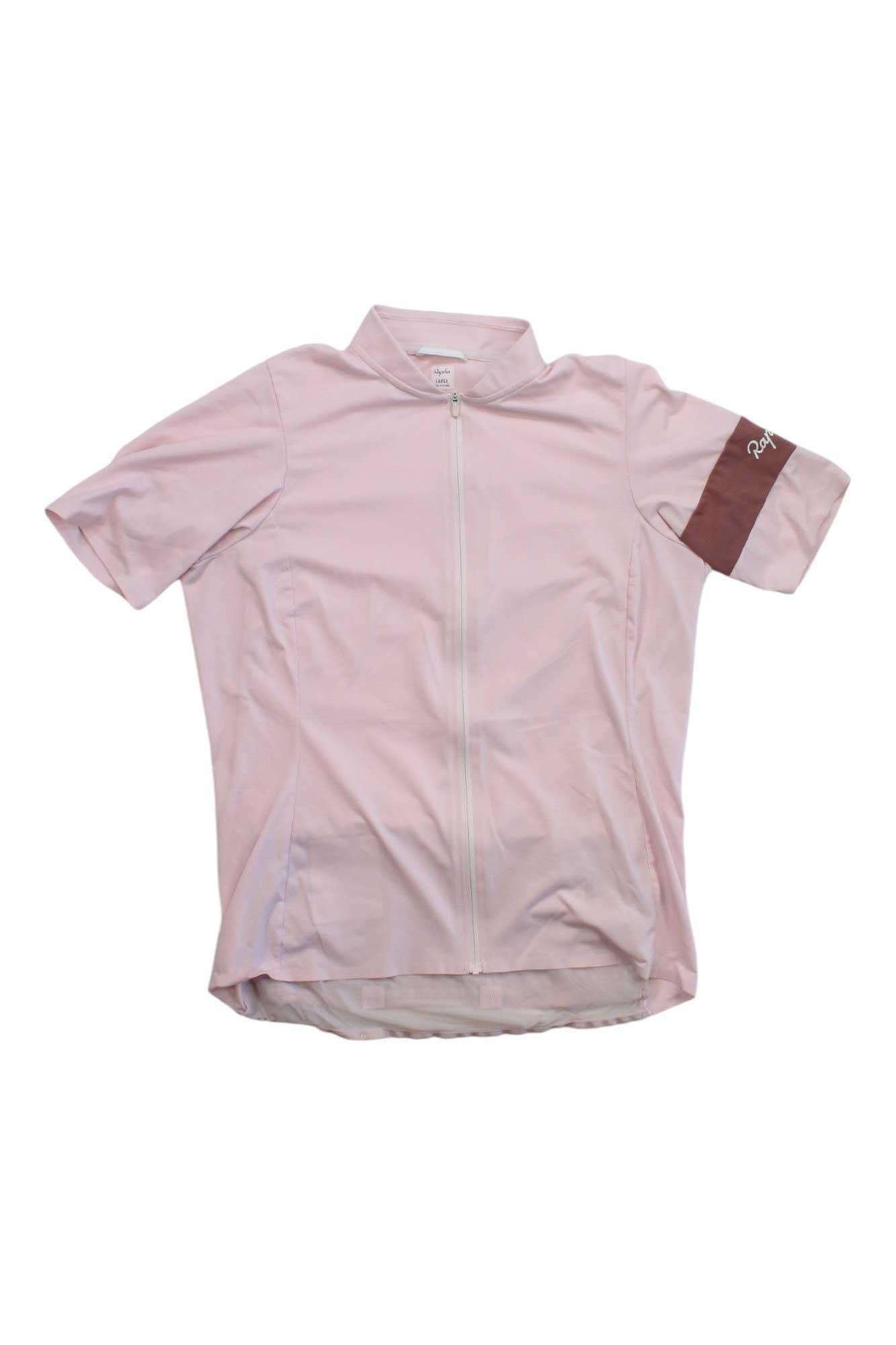 The Rapha Womens Classic Flyweight Jersey is a lightweight, short-sleeved cycling top in light pink with a darker pink left arm band, featuring a full front zipper and shown laid flat on a white background.