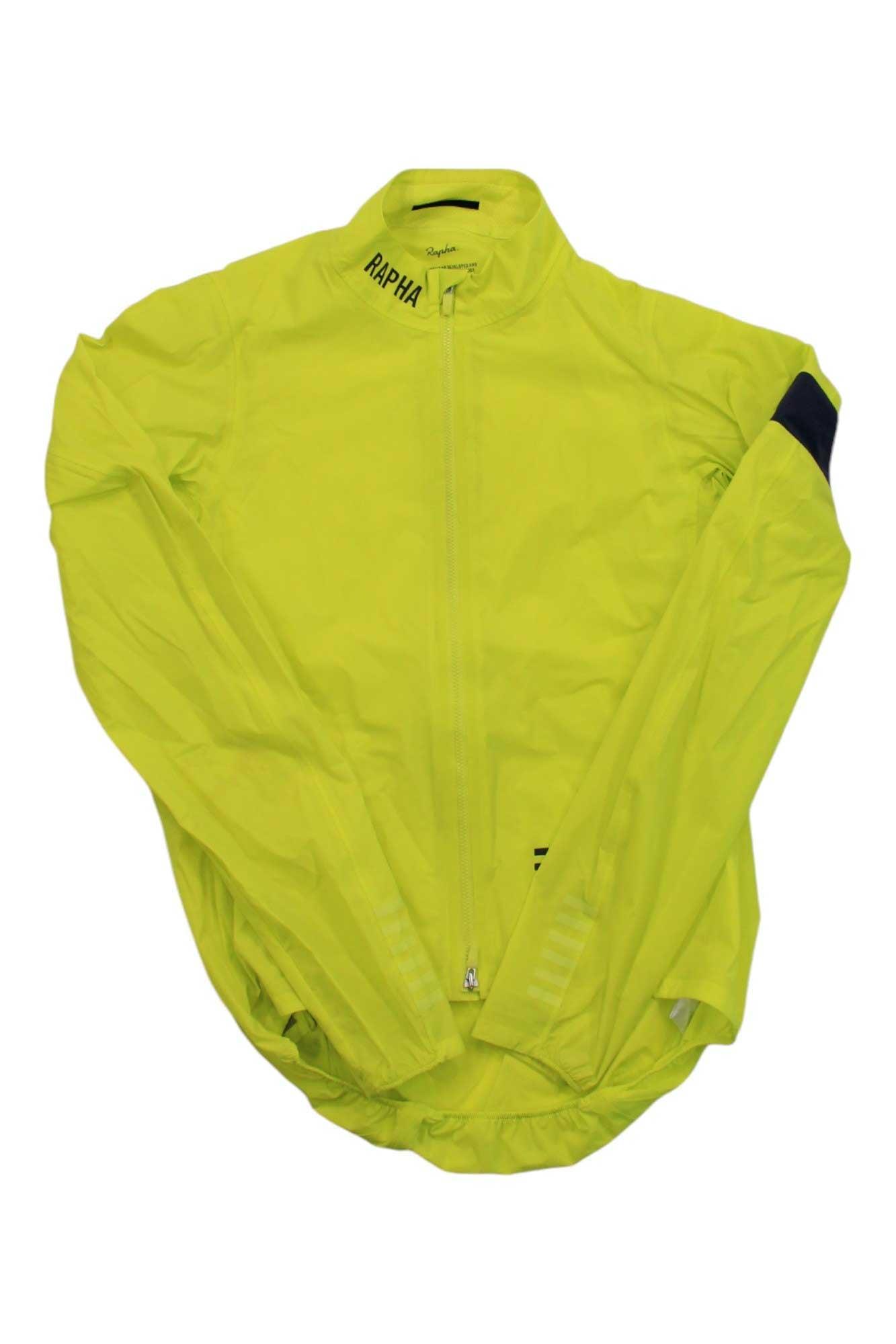 The Mens Pro Team Lightweight Shadow Jacket is a bright yellow, water-resistant cycling jacket with a full front zipper, high collar, Rapha logo near the neck, and a stylish black detail on one sleeve.
