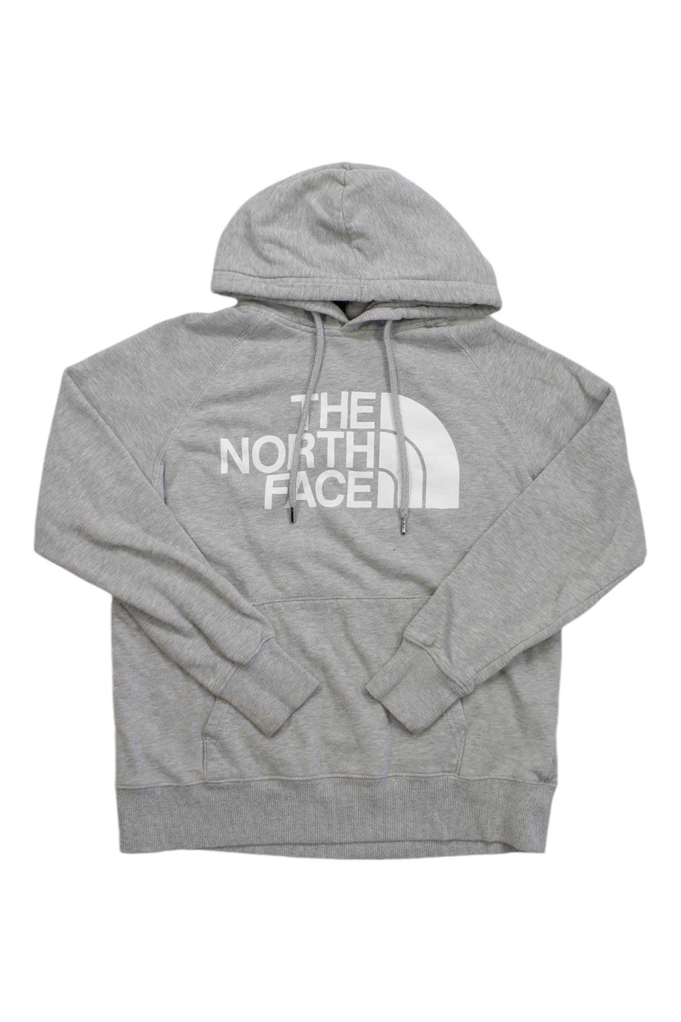 The North Face Womens Half Dome Pullover Hoodie in light gray features a hood, drawstrings, front pouch pocket, and a large white logo across the chest, shown on a white background.
