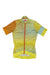 The Rapha Tunnel Vision Women's PT Training Jersey is a short-sleeve cycling top with a geometric pattern in yellow, orange, blue, and green. It features a front zipper, collar, and breathable panels in both lined and solid colors.