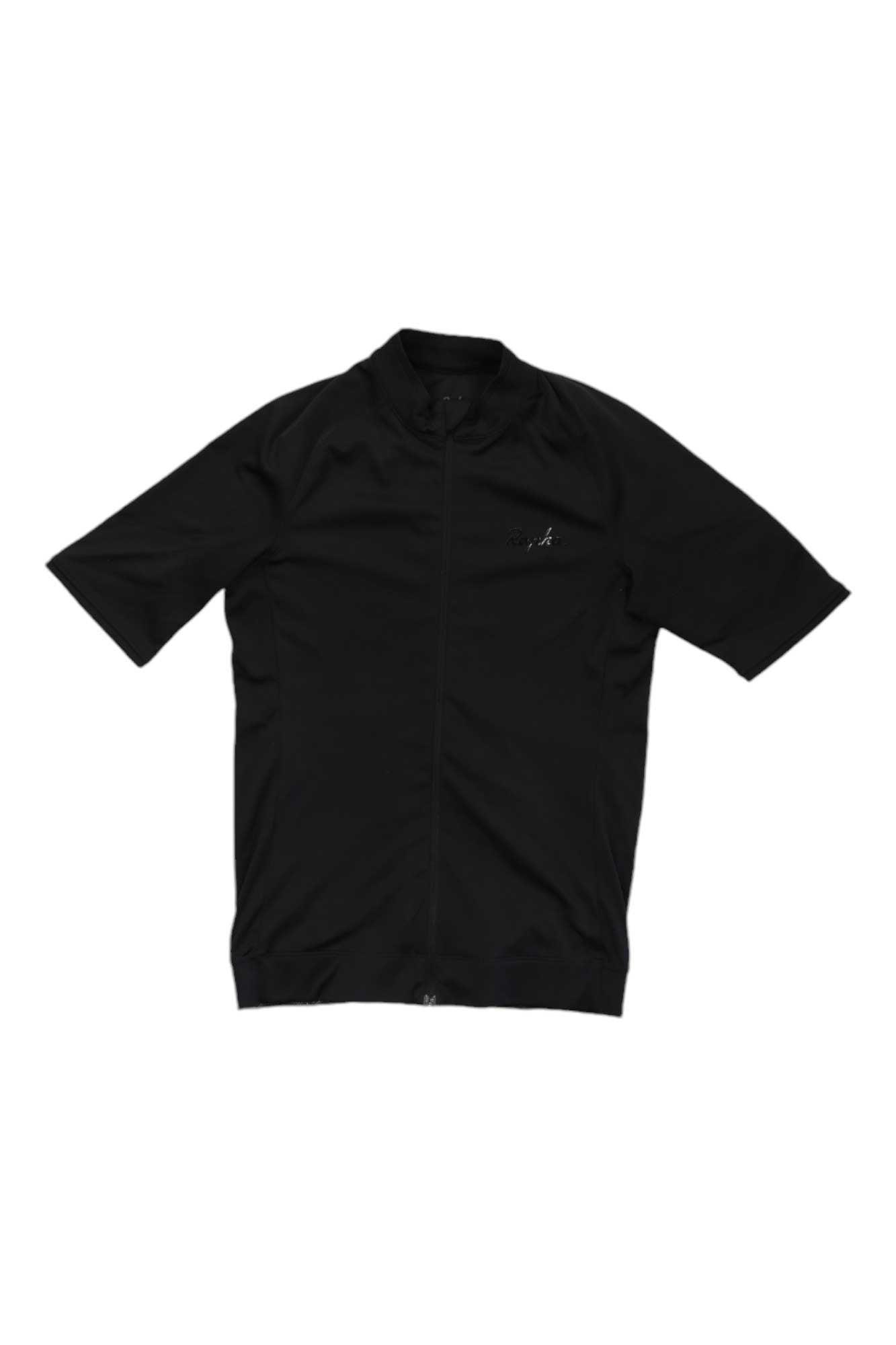 The Rapha Women's Core Jersey is a black, short-sleeve cycling top with a front zipper and small chest logo, shown laid flat on a white background. Designed for comfort and performance, this jersey offers breathable wear for cyclists.